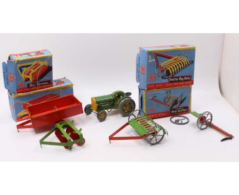 A collection of various boxed and loose Mettoy tinplate and clockwork tractors and agricultural equipment to include an unbox