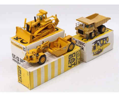 A collection of three boxed Caterpillar related 1/50 scale diecast vehicles to include an NZG 222 Caterpillar 769C dump truck