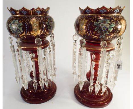 A pair of Bohemian ruby glass gilt and enamelled lustre's 36cms tall       Ruby glass vases basically sound some enamel wear 