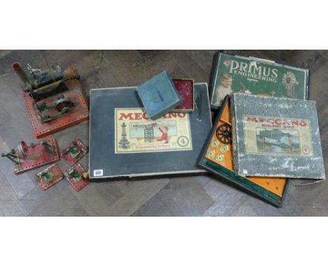 Three boxed sets of Meccano and Meccano accessories to include a miniature static steam engine together with engineering tool
