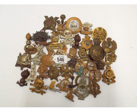 Collection of military cap badges and shoulder titles to include army cyclists, Royal Engineers, Warwickshire Regiment, Artis