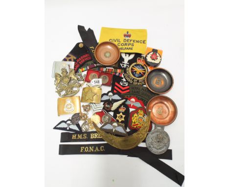 Mixed lot of military items to include Navy cap tallies, British Army badges, medallions, belt buckles, helmet plates etc. 