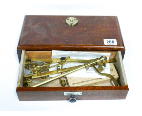 A set of brass balance scales on mahogany base
