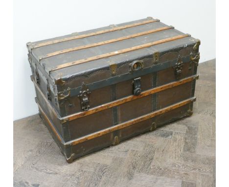 A large canvass wood and metal bound trunk 