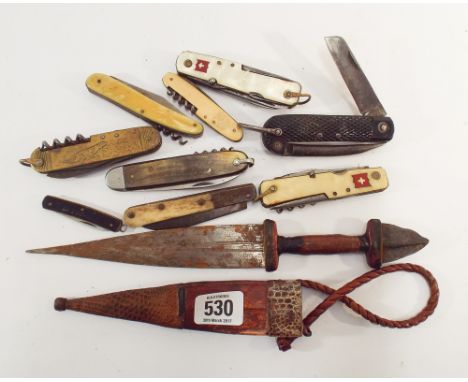 A collection of 19th century pen knives, military Swiss army knife together with an African dagger in its leather covered sca