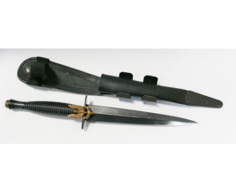 Army commando knife with its leather scabbard and applied SAS badge with motto 'who dares wins'.  Blade length 7" 