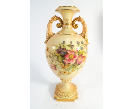 A Royal Worcester blush ivory twin handled vase painted with floral sprays number to base 2443 height 24cms tall 