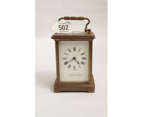 A brass carriage clock by W Burford & Sons Ltd of Exeter and Eastbourne glass panel to top, sides and door 12cms tall by 8cms