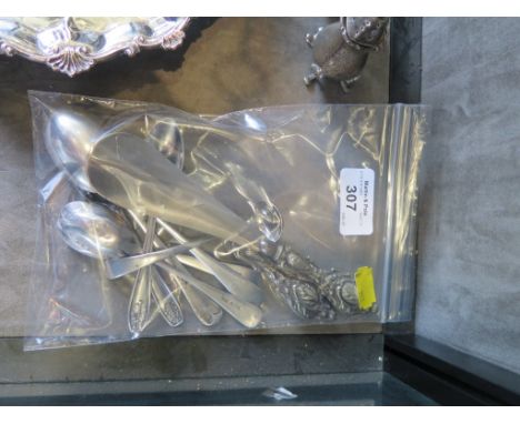 A collection of silver spoons, a button hook and a shoe horn