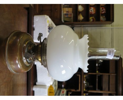 A brass oil lamp, with opaque glass shade 43cm high