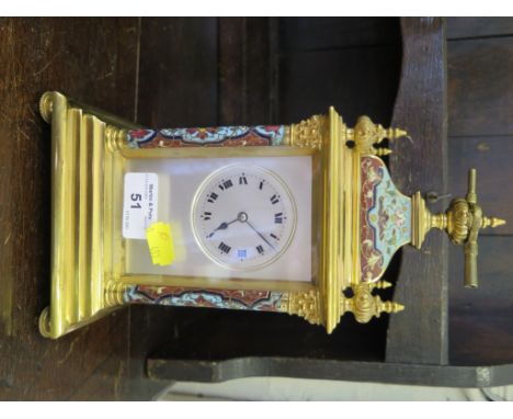 An Edwardian brass and champsleve enamel mantel clock, the caddy top and finials over a silvered dial, moulded base and beade