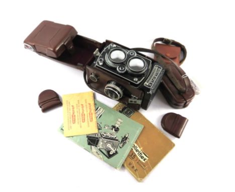 A Rolleiflex 3.5 TLR camera, with Planar 75mm 1:3.5 lens case no. 1756980, with manual, lenses and hood