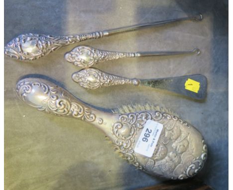 A silver ladies hair brush depicting Reynolds angels, a silver handle shoe horn, two button hooks and a cased Victorian silve