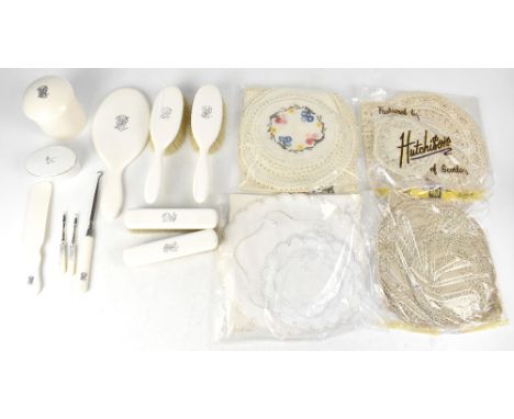 An Edwardian ivory coloured eight-piece dressing table set, two ladies' hair brushes and mirror, two gentlemen's brushes, a s