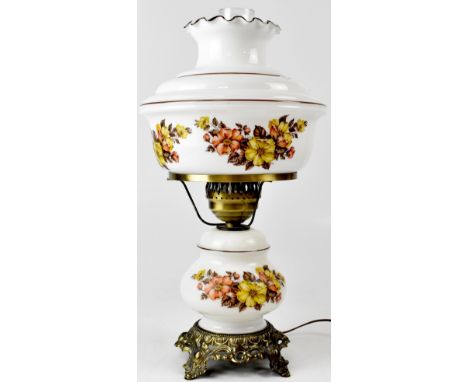 A 20th century white glass oil lamp with floral decorated base and oil reserve to a decorative brass circular stand, height 5