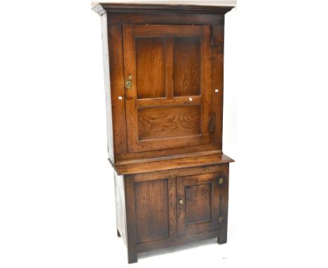A late 18th century oak kitchen food storage cabinet, stepped cornice above single three-panelled door with three interior sh