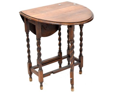 An early 20th century oak drop-leaf gateleg table with wrythen supports and stretchers, when extended 89cm and a 19th century