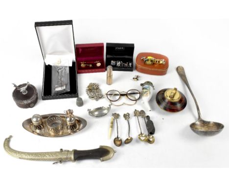 A collectors' lot to include a coin bracelet, a Calibri table lighter, plated ware to include cruet set, ladle, ornamental bo