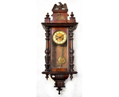 An early 20th century mahogany cased Vienna-style spring-driven wall clock, the chapter ring set with Arabic numerals, surmou