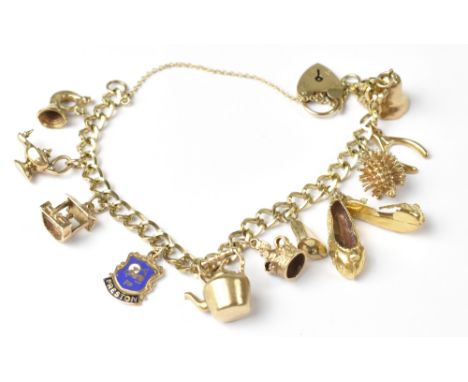 A 9ct gold charm bracelet with eleven gold charms to include a pair of slippers, Aladdin's lamp, hedgehog, kettle, well, crow