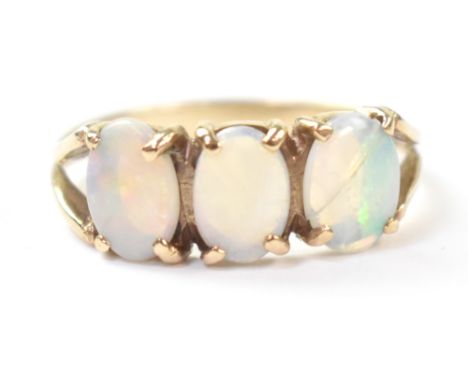 A 9ct gold three opal ring, the claw set white opals with hints of green and blue, on 9ct gold shank, size N/O, approx 2g. CO