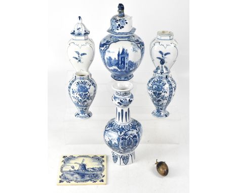 A collection of mainly early 20th century blue and white Delft ware to include a pair of baluster vases with covers, overall 