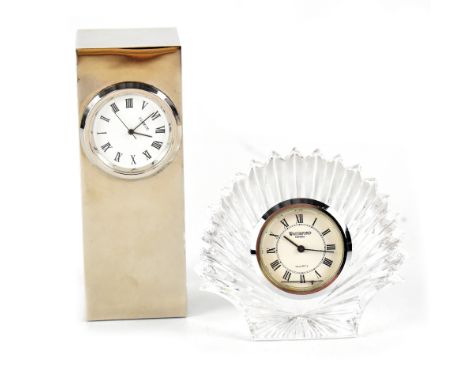 A miniature Waterford clock, the surround in the form of a crystal shell, the white dial set with Roman numerals and a quartz