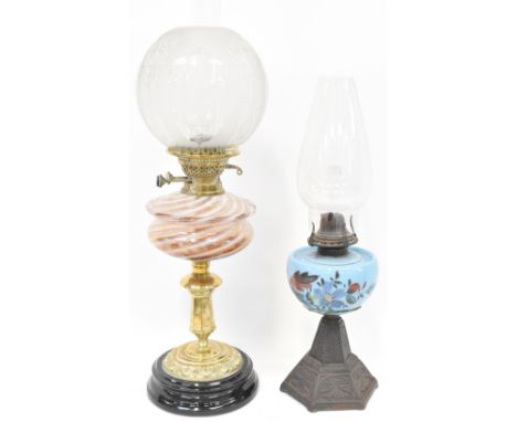 An Edwardian brass oil lamp with etched glass shade, brown humbug glass reserve to column brass and black stepped base, heigh