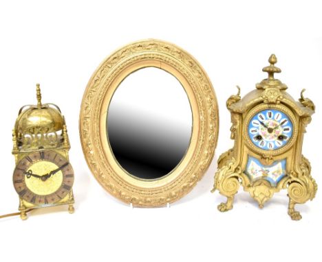 An early 19th century Sèvres-type mantel clock, the painted and blue enamelled dial set with Roman numerals, with ornate gold