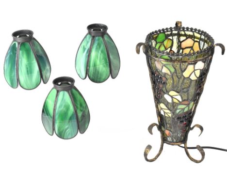 A Tiffany style lamp on wrought iron stand and three modern green stained glass effect lamp shades (4). CONDITION REPORT All 