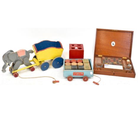 A group of vintage wooden toys comprising a Chad Valley shape sorter, a pull-along elephant on wheels, a cart and a Rattle Br