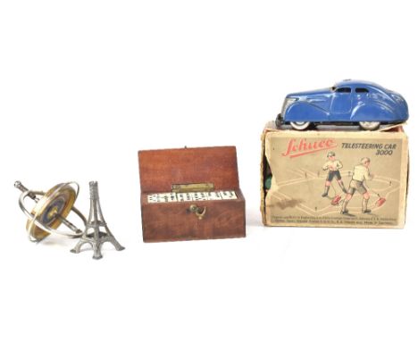 A vintage Schuco Telesteering Car 3000, the blue car with twelve wooden coloured markers, winding key, wooden ball, steering 