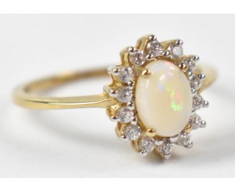 A 9ct yellow gold ring set with central opal surrounded by cubic zirconium, size N, approx 2g.