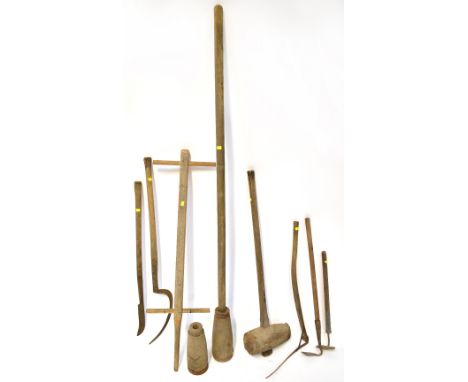 Various farm and vintage garden tools to include a wooden and steel post hammer, a vintage post hole pounder with steel colla