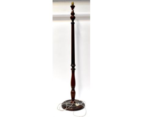 An early/mid-20th century mahogany standard lamp with slender reeded stem, to baluster and spreading circular base, height 14