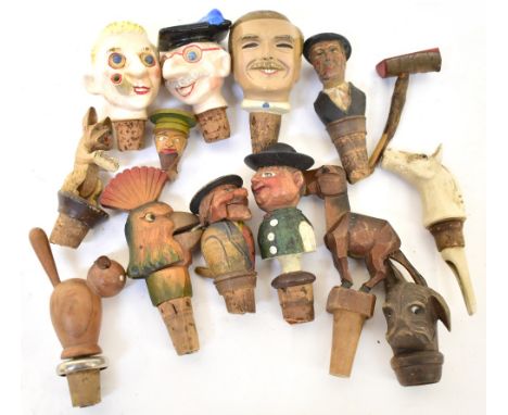 Thirteen vintage Black Forest style novelty and automaton bottle stops, four with painted porcelain heads to include a school