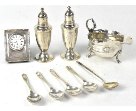 A George V hallmarked silver sauce boat, Birmingham 1927, a pair of loaded sterling silver cruets, four silver coffee spoons,