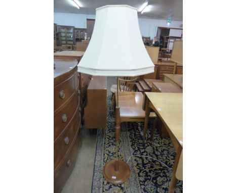 A teak and brass standard lamp 