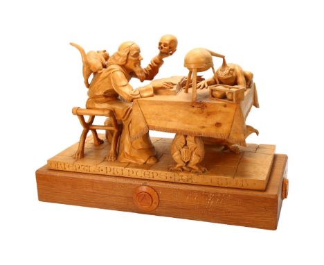 Ian Norbury, superb quality lime wood carving, Merlin, seated at a table and holding skull and cat, a toad on the table morph