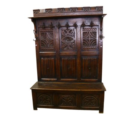 A 19th century carved oak, linenfold, high-back settle/hall-stand, with shelf over hooks and box seat, height 190cm, width 13