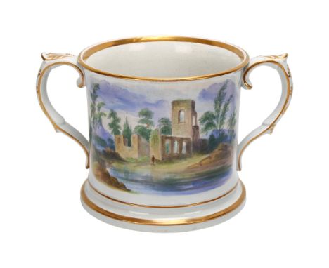 A large 19th century English pottery 2-handled loving cup, with hand painted scene depicting church ruins and gilded decorati