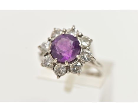 AN AMETHYST AND DIAMOND CLUSTER RING, set with a principal amethyst, measuring approximately 8.08 x 8.11mm x depth 6.00mm, su