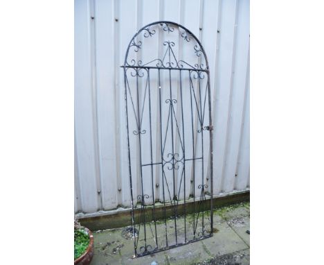 A WROUGHT IRON ARCH GARDEN GATE with foliate detailing width 85cm height 210cm