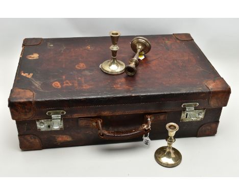 AN EARLY 20TH CENTURY BROWN LEATHER DRESSING SUITCASE IN WORN CONDITION, containing five silver topped glass jars, four of wh