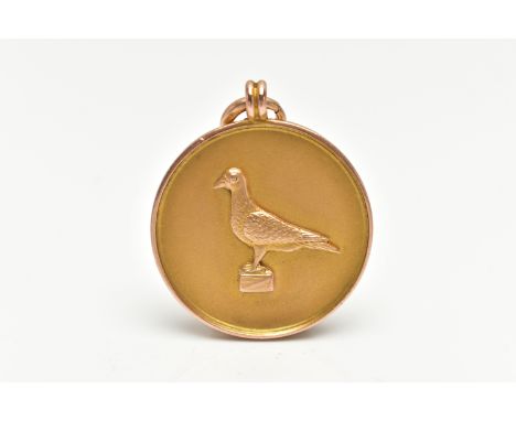 A 9CT GOLD FOB MEDAL, of a circular form, depicting a pigeon to the front, reverse has a personal inscription which reads 'J.