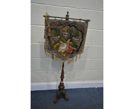 A VICTORIAN MAHOGANY POLE SCREEN, with a floral needlework hanging tapestry, on turned shaft, with three shaped legs, with le