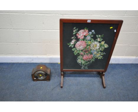 A MAHOGANY FRAMED TILT TOP NEEDLE WORK FIRESCREEN/TABLE, and a mantel clock (condition - domed door for clock held on with ta