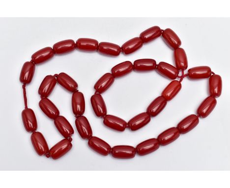 A CHERRY AMBER BAKELITE BEAD NECKLACE, designed with a single row of thirty-five barrel shape beads, each measuring approxima