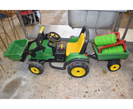 A child's ride on tractor with trailer, branded John Deere