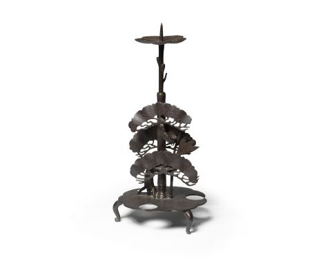 MYOCHIN FAMILYAn Unusual Iron Candlestick Modelled with a Design of Shochikubai (Pine, Bamboo and Plum, the 'Three Friends of